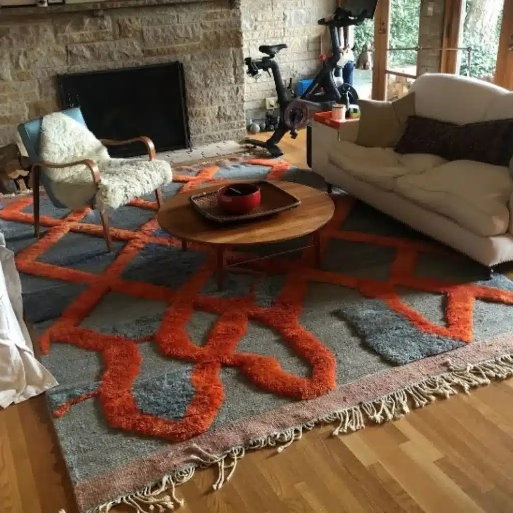 colorful washable area rug with bold abstract pattern in a modern living room with sofa and wooden coffee table