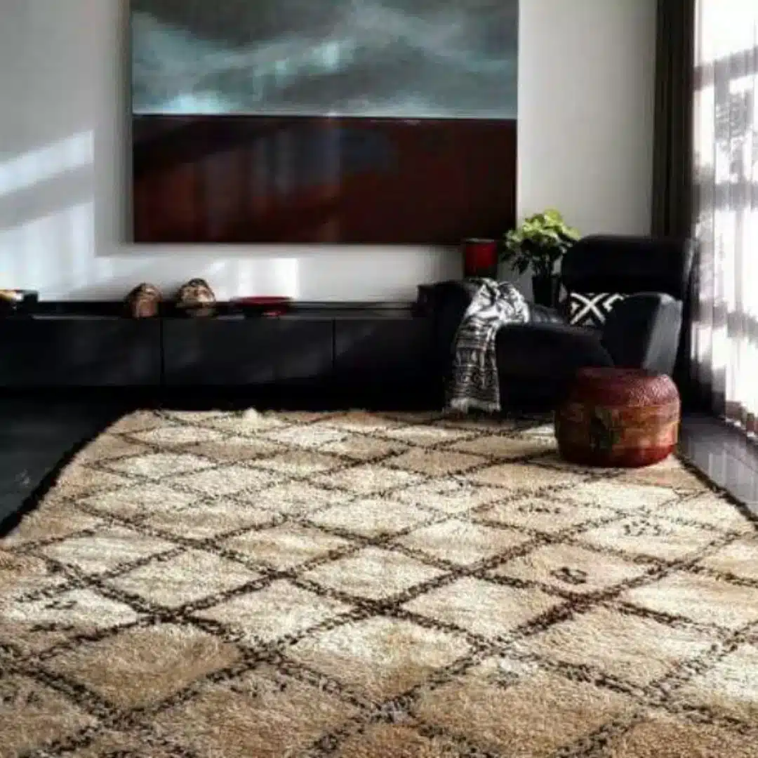 soft Moroccan Beni Ourain washable rug in a dark modern living room with armchair
